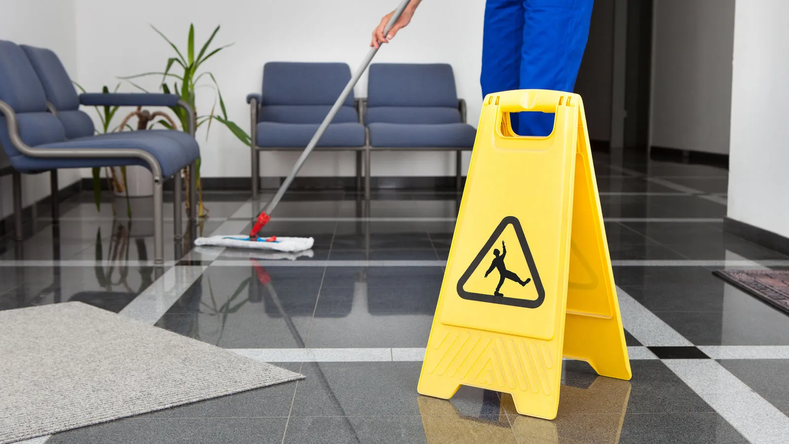 Cleaning professional mopping the floor of a San Antonio office lobby